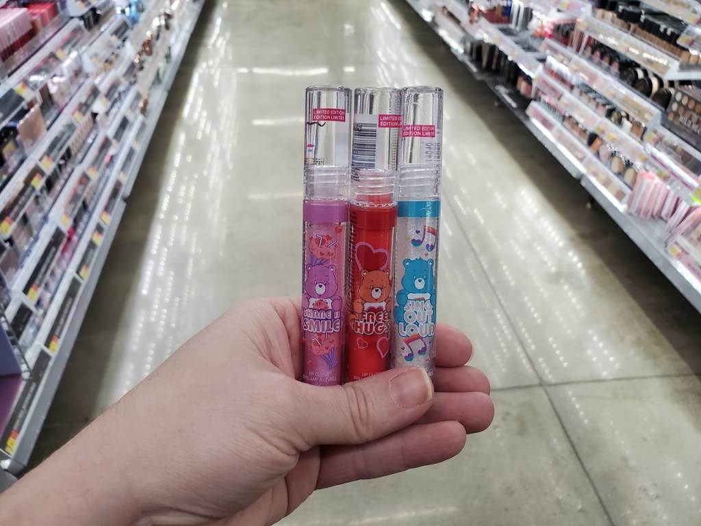 hand holding up Care Bears Lip Glosses