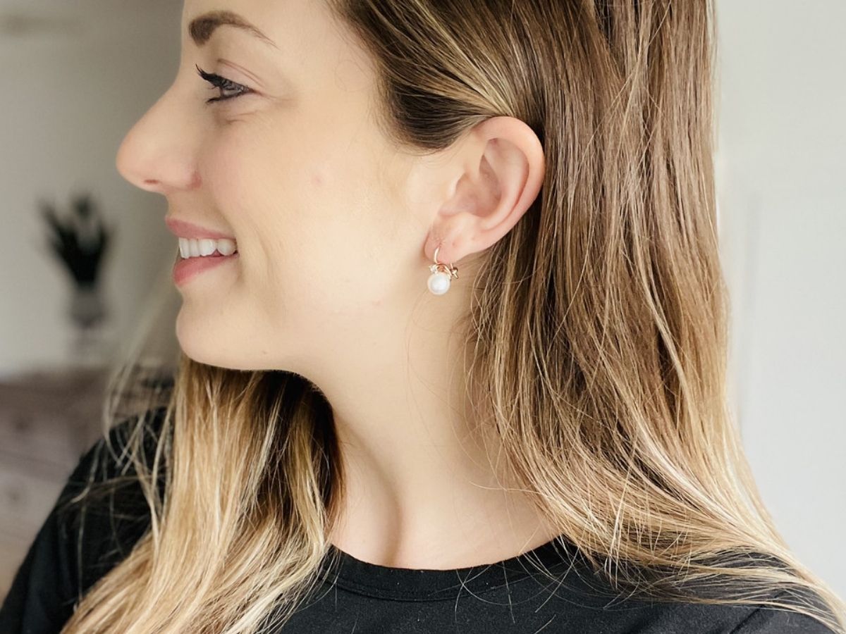 woman wearing pearl drop earrings