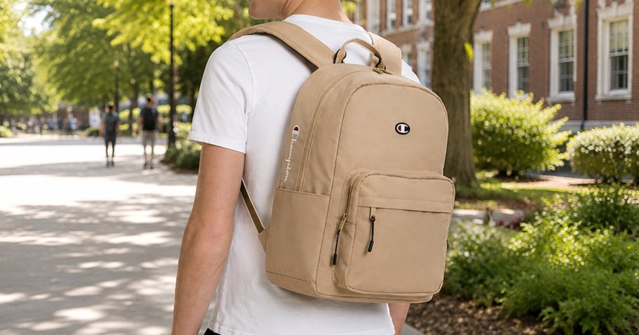 man wearing a white tee and tan champion backpack