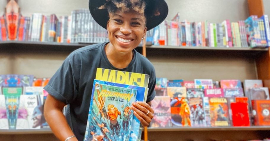 woman holding a comic book at free comic book day
