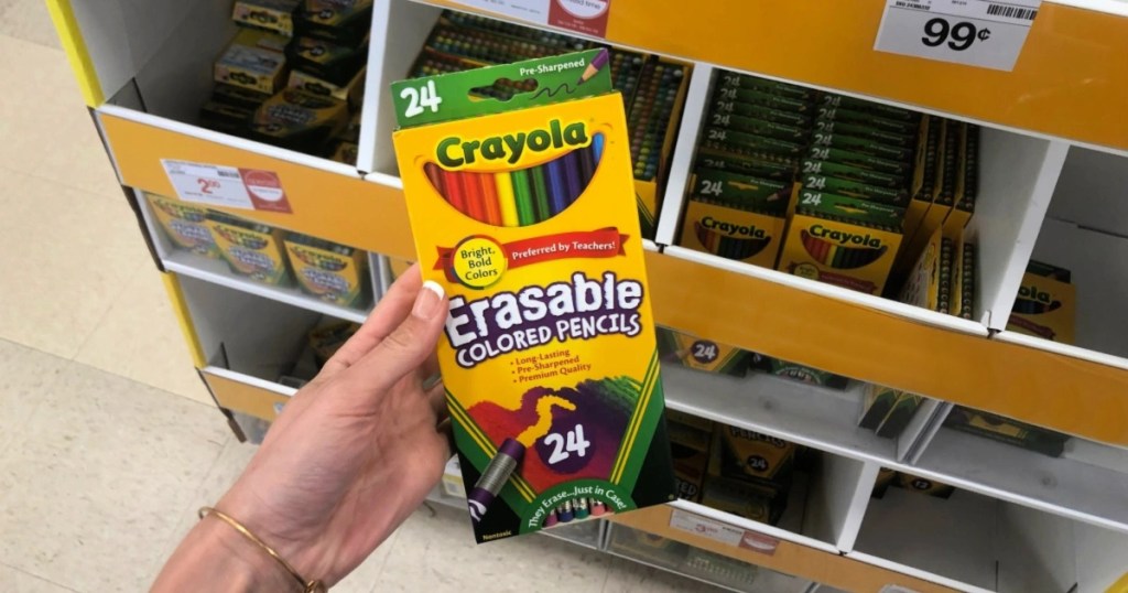 holding a package of 24 colored pencils
