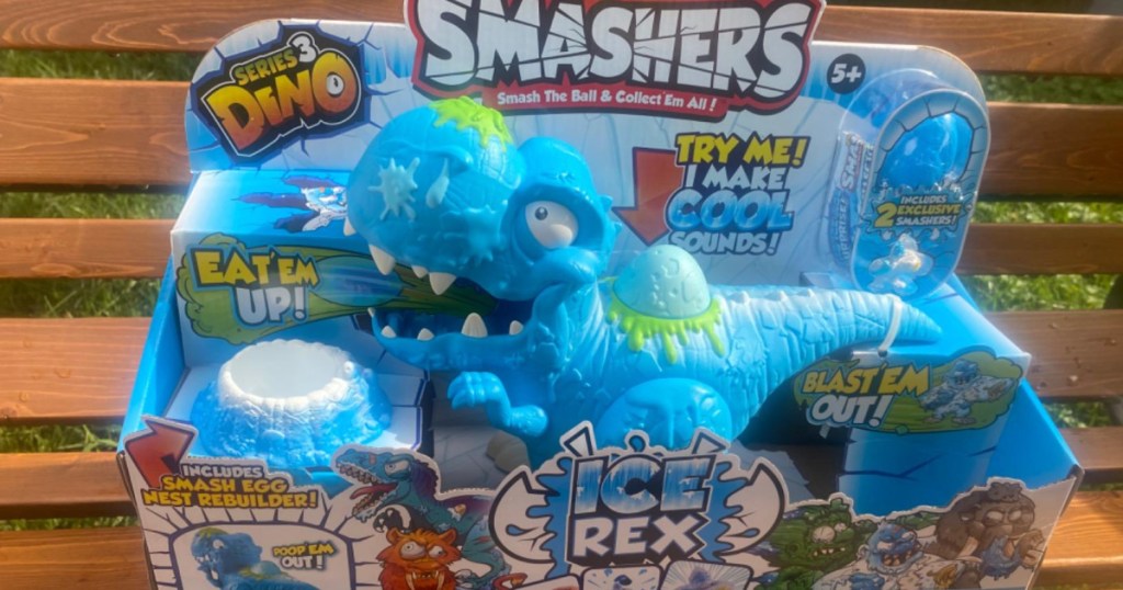 Blue dinosaur toy in packaging sitting on bench