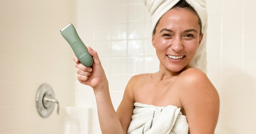 Girl holding Meridian trimmer in shower