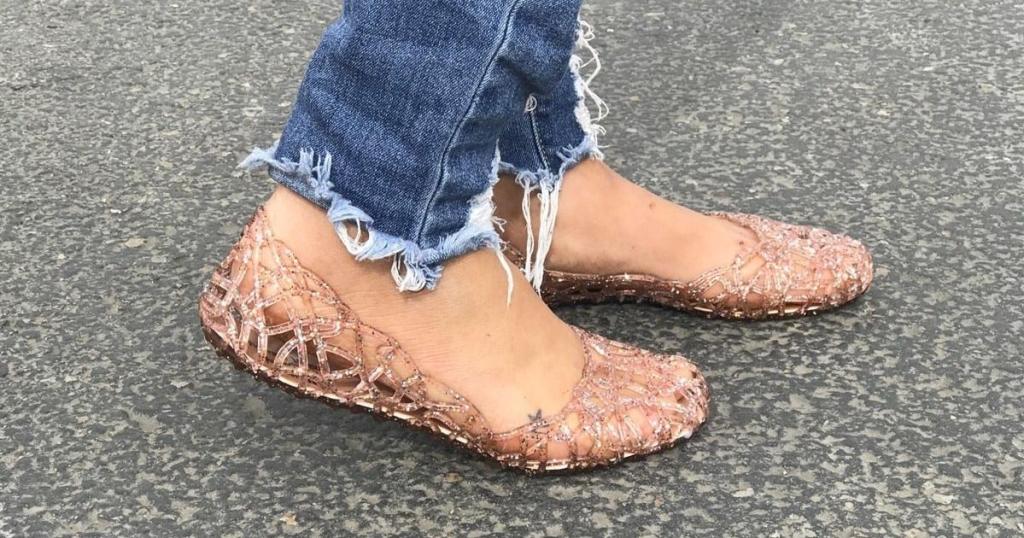 woman wearing glitter jelly shoes