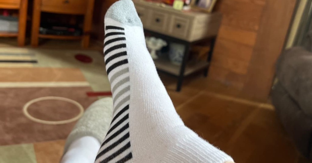 foot in black and white print sock in living room