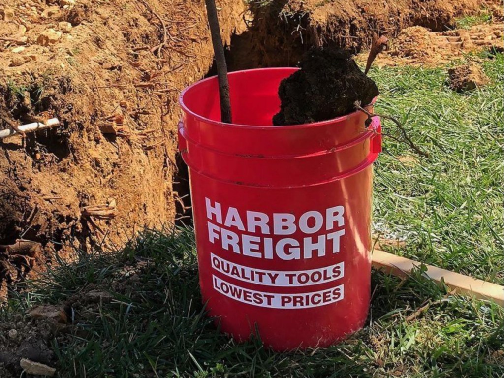 red harbor freight plastic work bucket in grass
