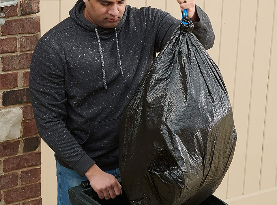 man holding a Hefty Trash Bag