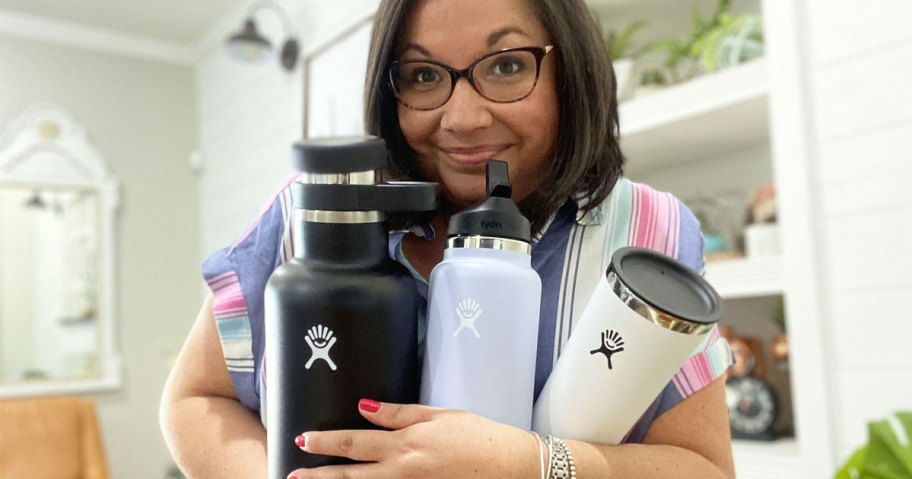 woman holding hydro flask bottles