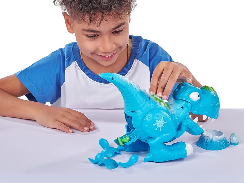 child playing with blue dinosaur toy