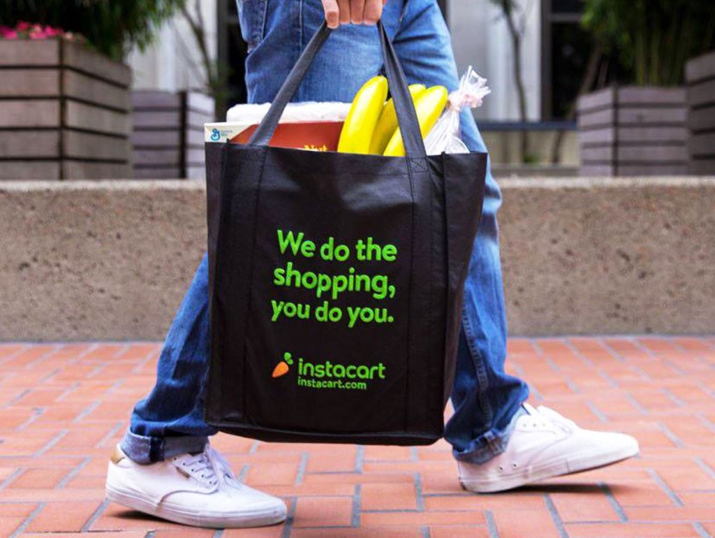 person holding instacart bag