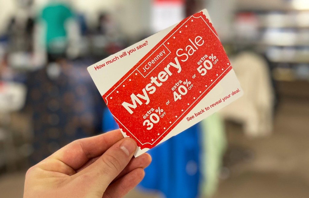 hand holding jcpenney mystery coupon