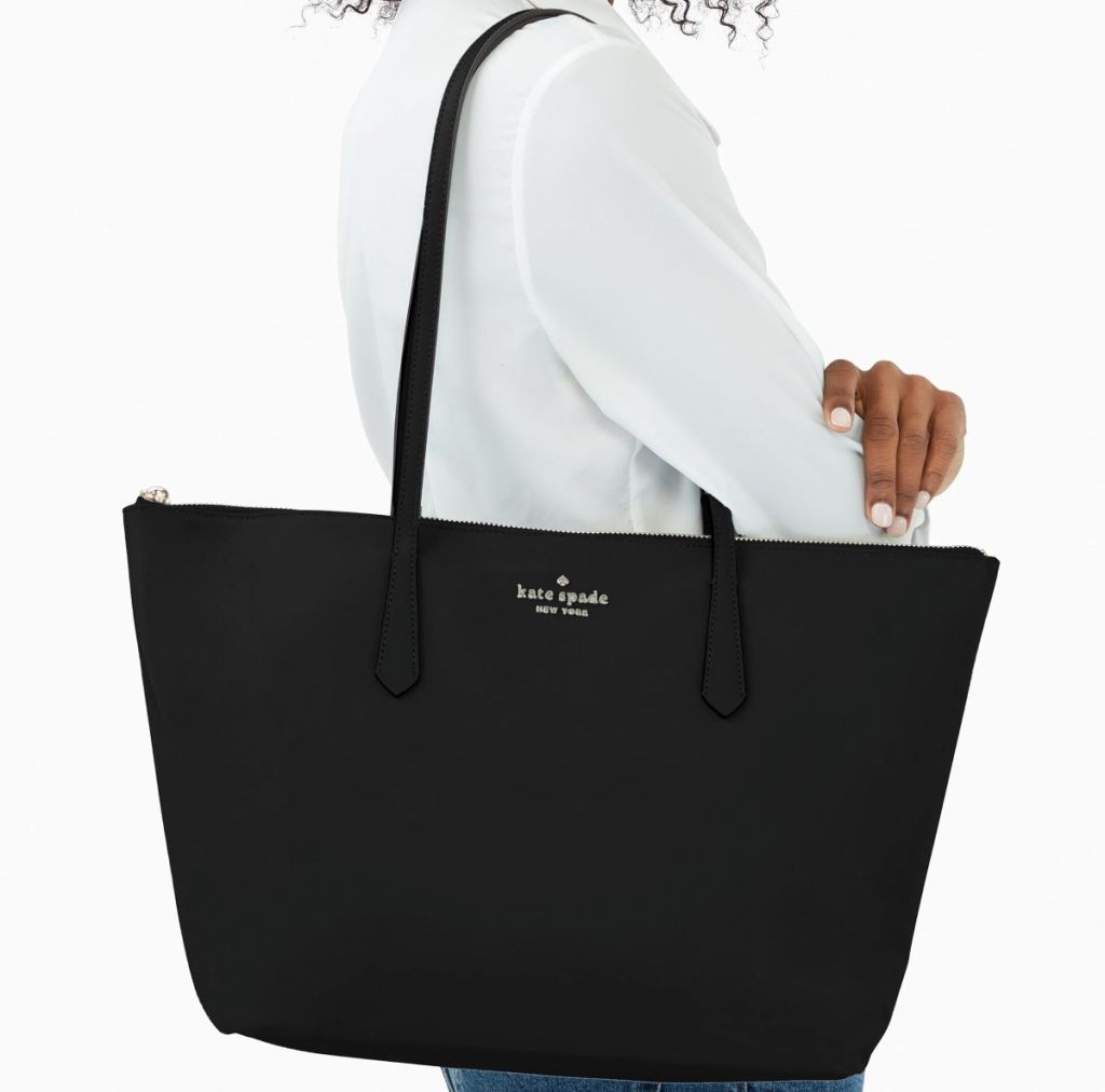 woman carrying a Kate Spade tote