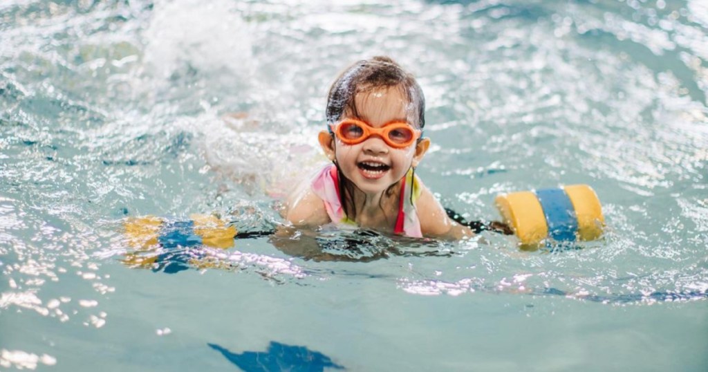kid with goggles swimming in lap pool