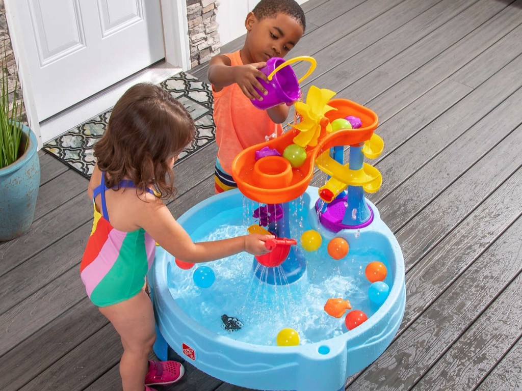Kids playing with Step 2 Rushing Rapids Water Table