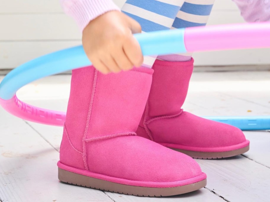 young girl wearing hot pink koolaburra by ugg boots