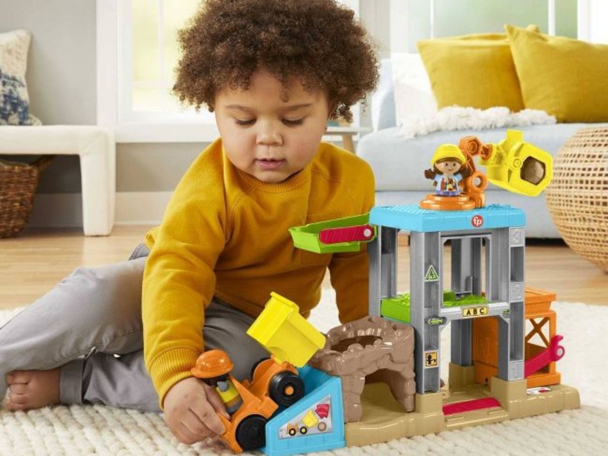 kid playing with Little People Construction set 