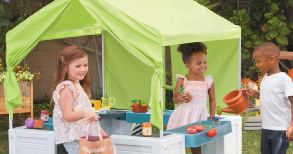 kids in front of green tent play set 