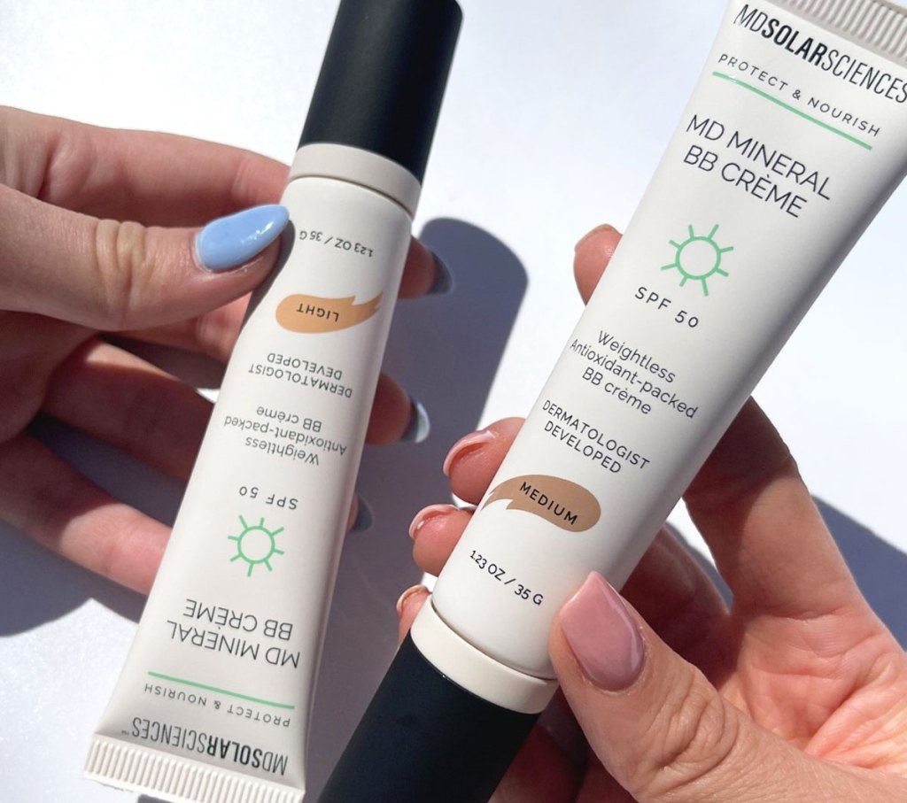 hands holding two tubes of MDSolarSciences MD Mineral BB Crème