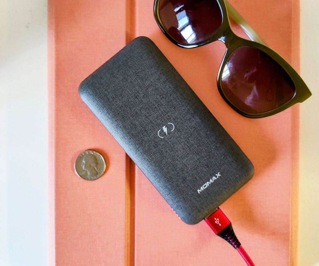grey wireless charger on top of a tablet with sunglasses