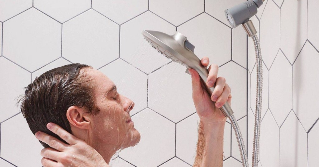 Man in shower with handheld showerhead