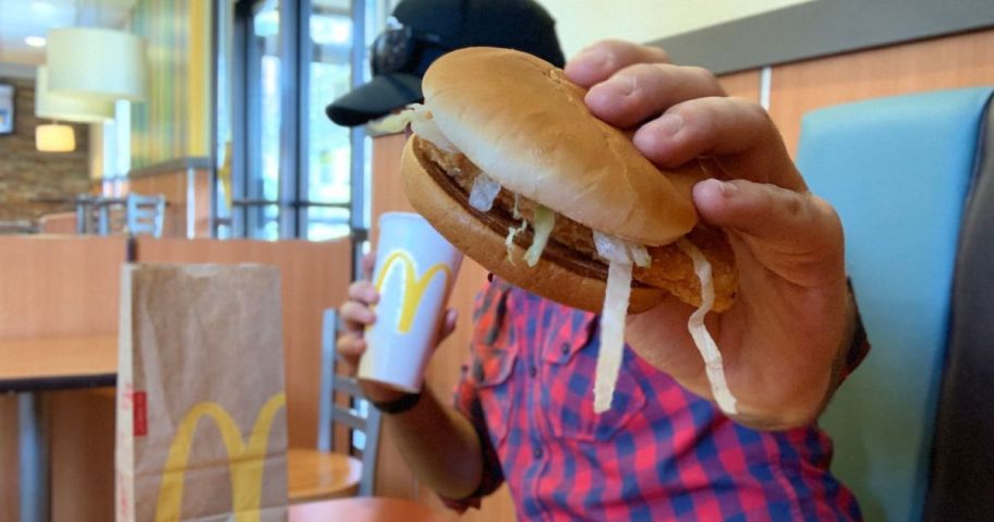 man holding a McDonald's McChicken