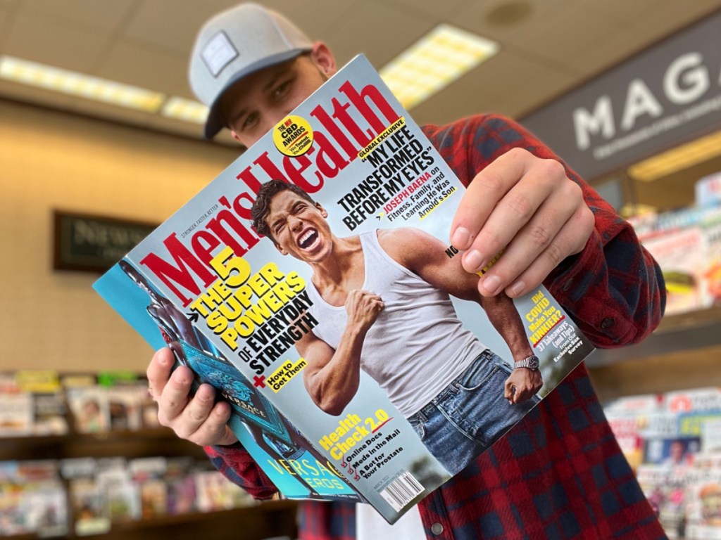 man reading Mens Health Magazine in store aisle