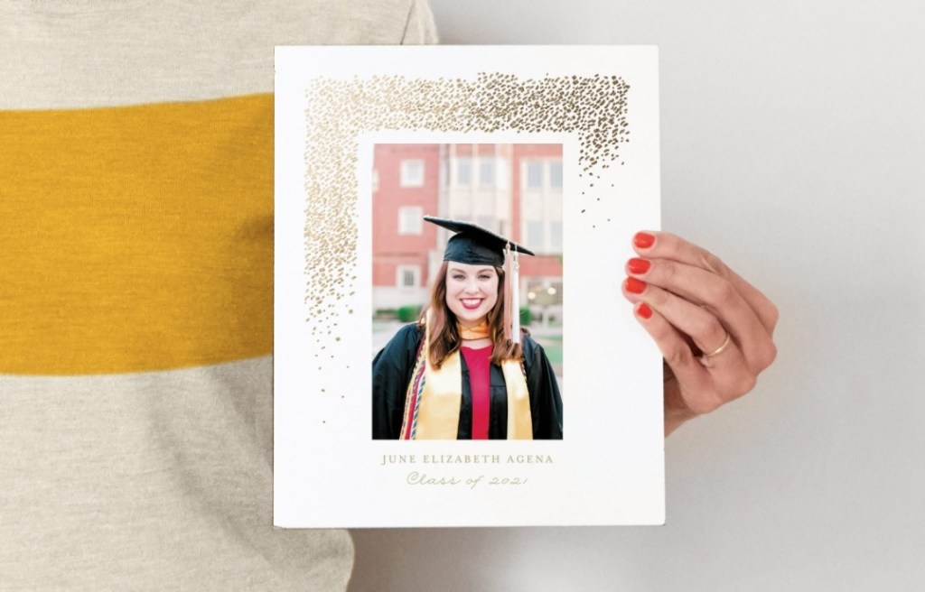 hand holding a picture of a graduate