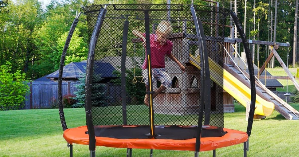 boy jumping on Moxie Trampolines 6' Pumpkin-Shaped Outdoor Trampoline Set