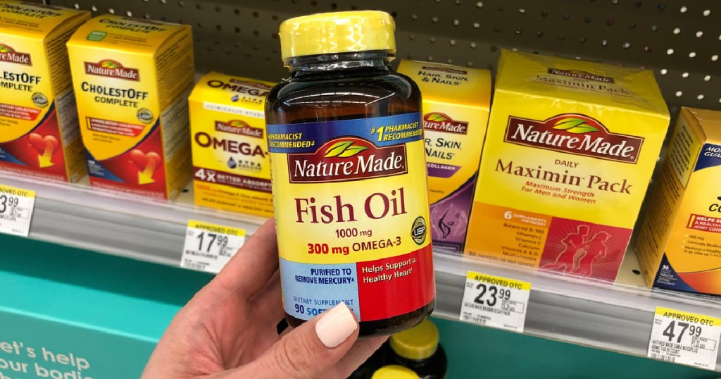 hand holding bottle of fish oil supplements