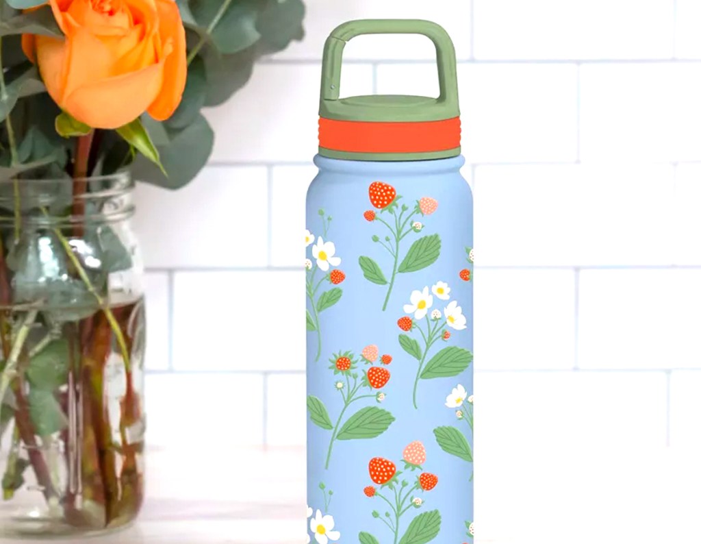 OCS Designs 20oz Stainless Steel Water Bottle with Strawberries and Lavender sitting on a counter
