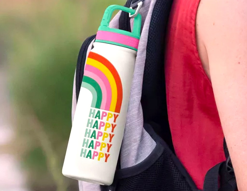 OCS Designs 20oz Water Bottle in Rainbow attached to a backpack being worn by a woman
