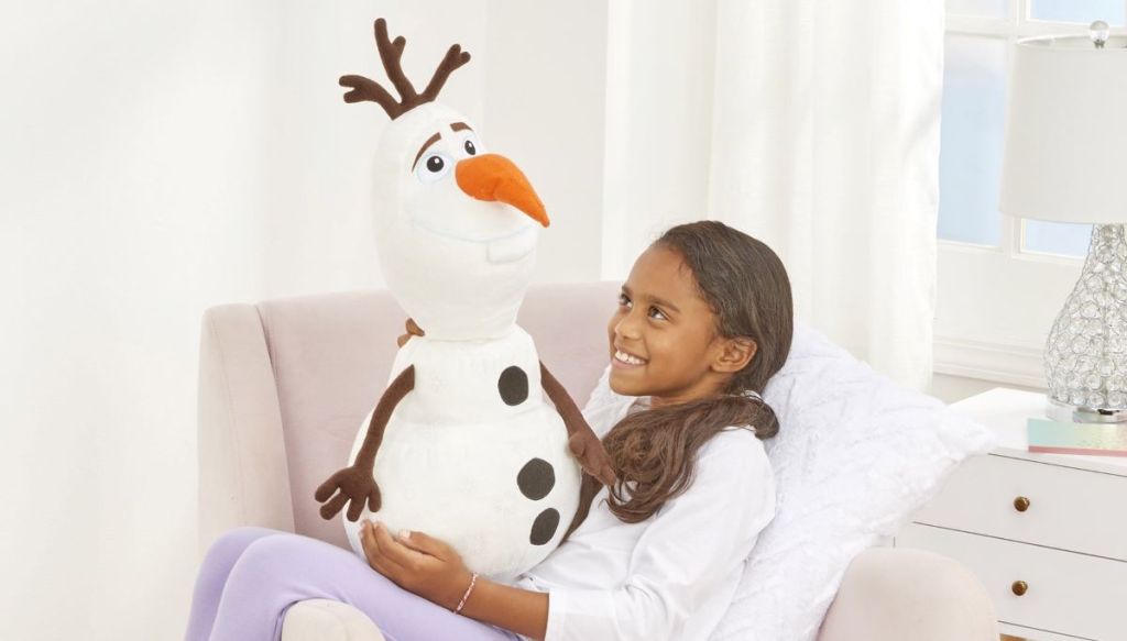 girl holding an Olaf plush