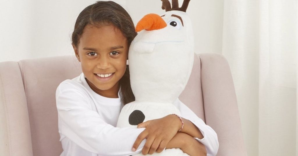 girl holding an Olaf plush