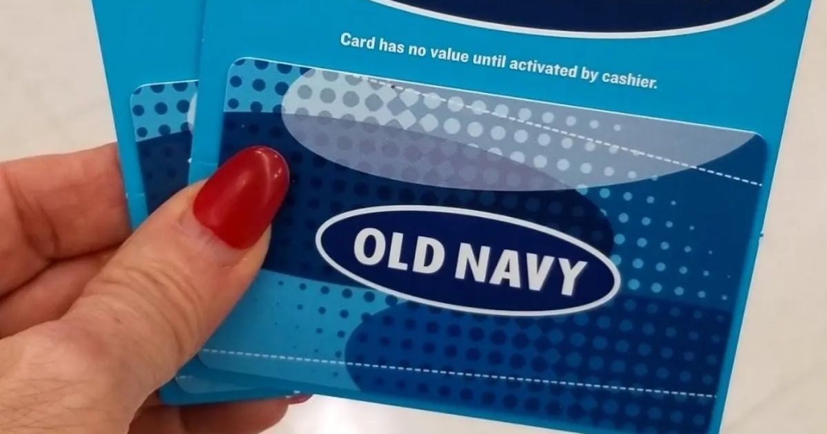 manicured hand holding two old navy gift cards stacked on top of each other