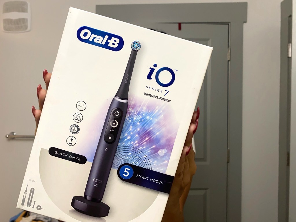 lady holding a Oral-b toothbrush