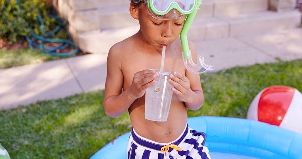 boy in bathing suit sipping panera drink