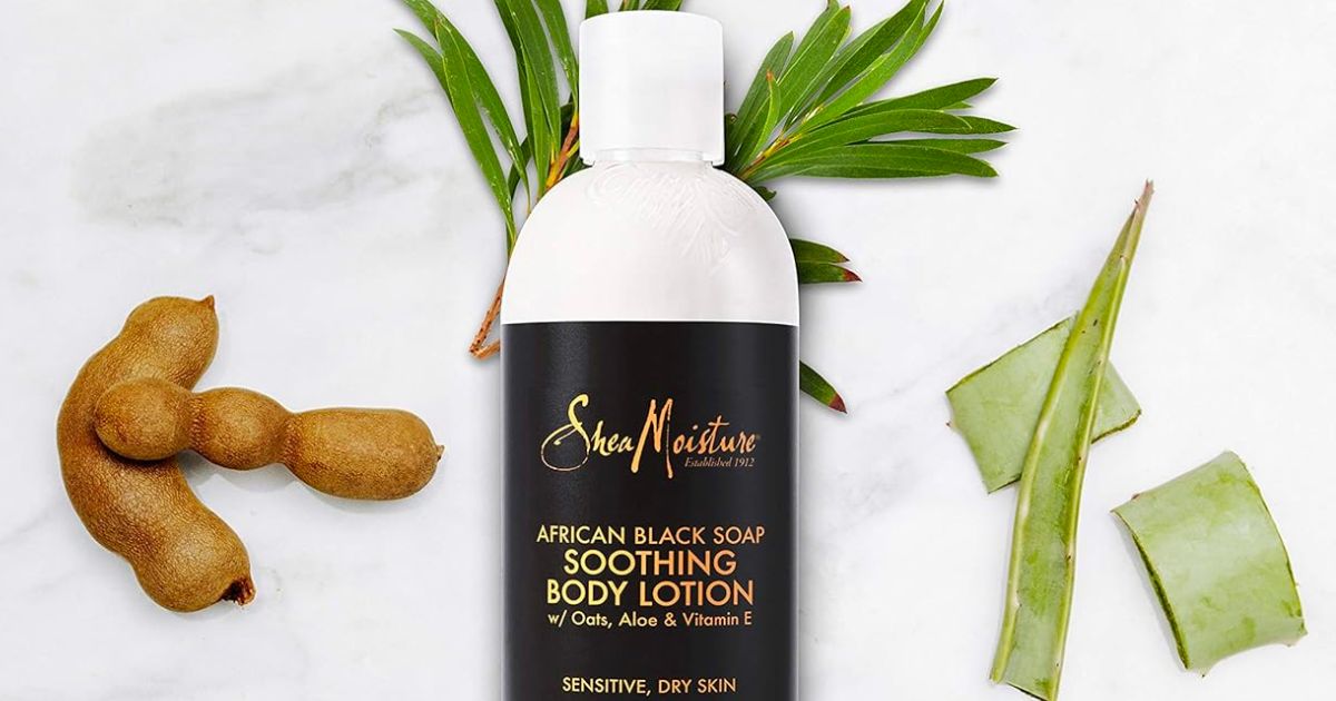 SheaMoisture Soothing African Black Soap Lotion for Troubled Skin 13oz 4 with raw ingredients on a marble table