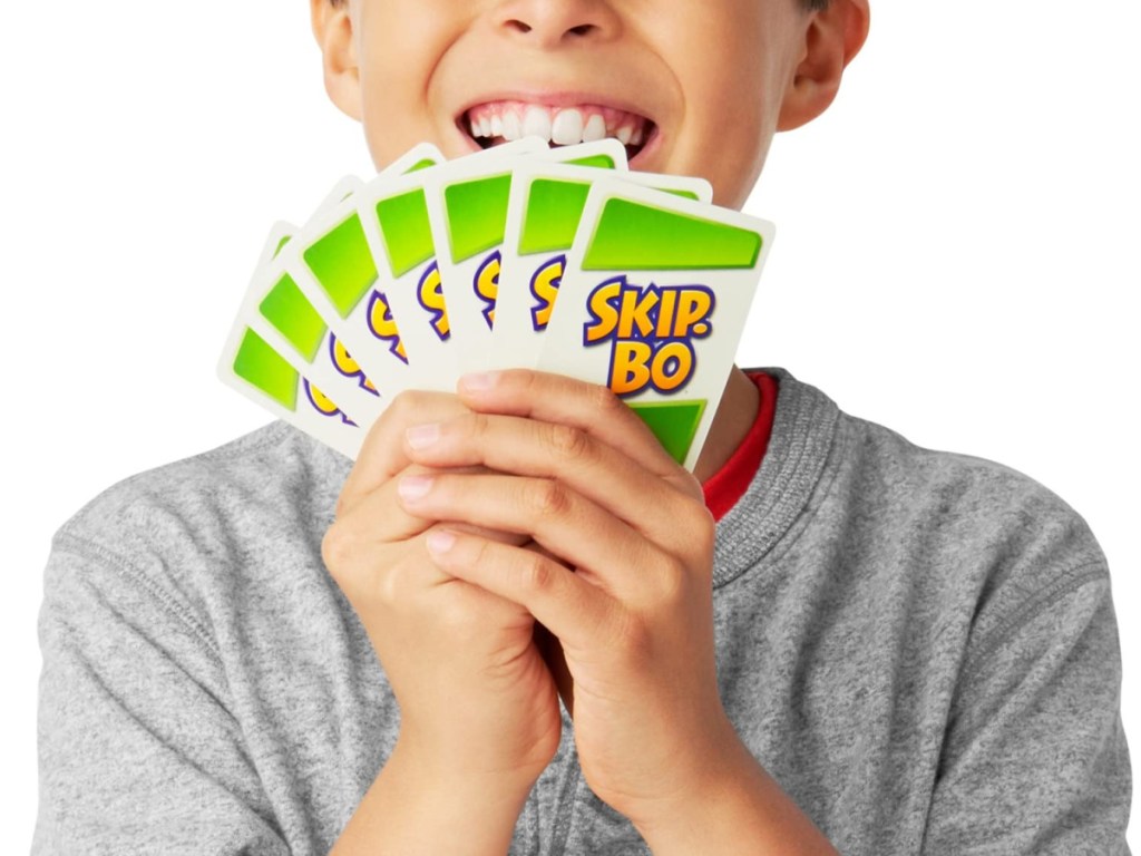 boy smiling and holding game cards