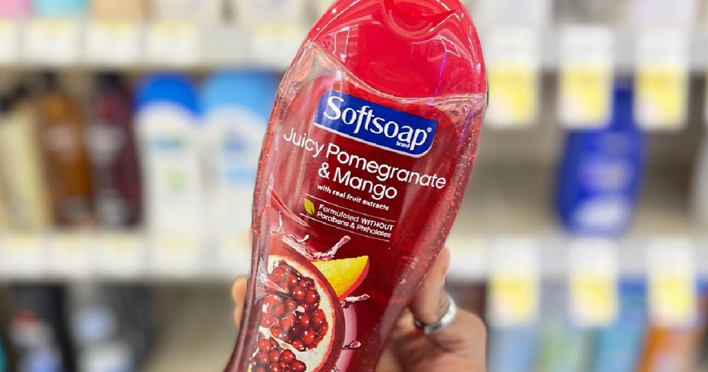 Hand holding up a bottle of Softsoap Juice Pomegranate Body Wash