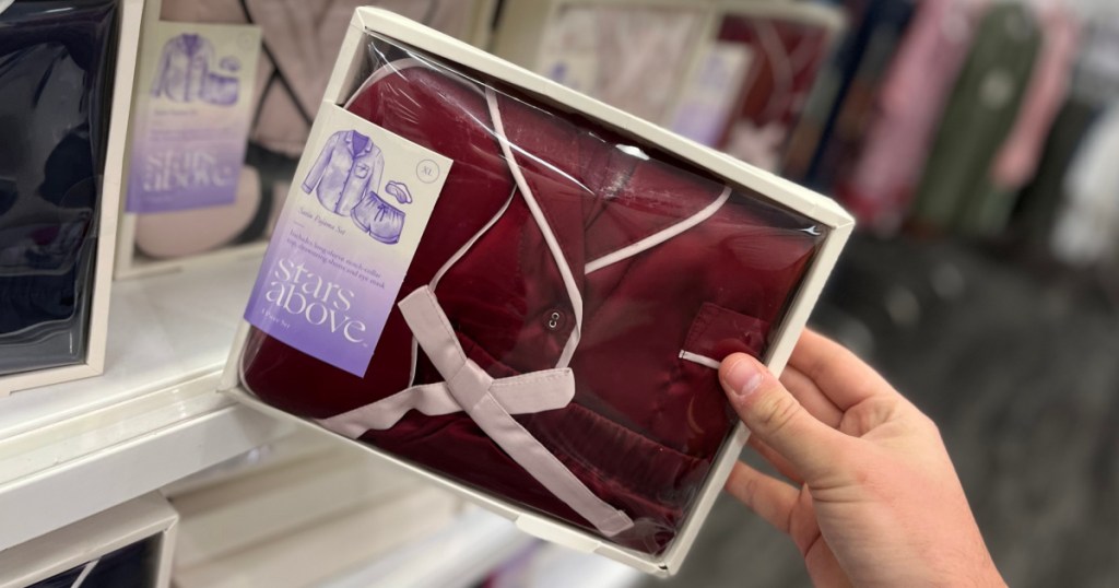 hand holding maroon pajama set in box