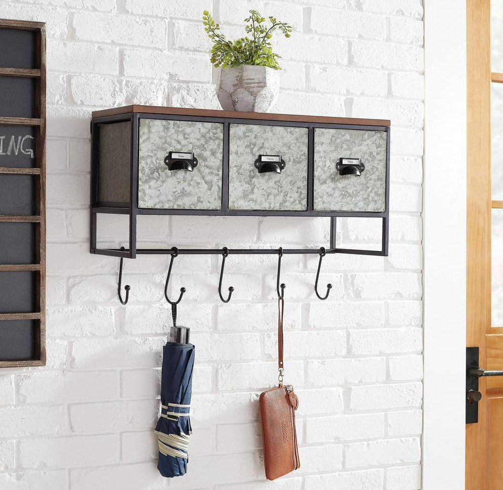 Metal and wood shelf with hooks on a wall