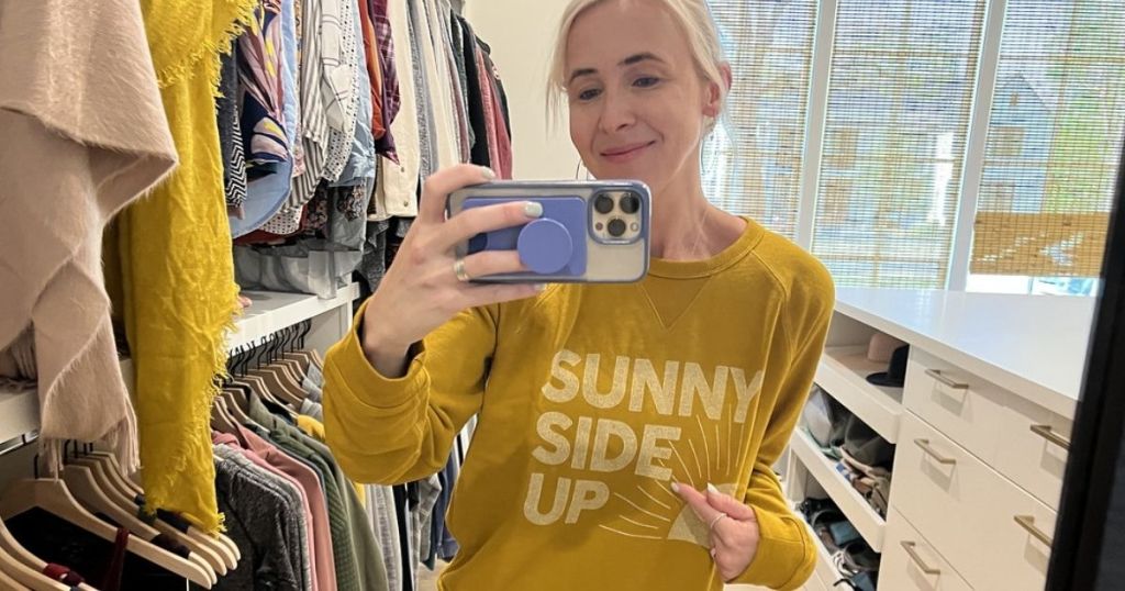 woman looking in mirror wearing Sunny Side Up Sweatshirt