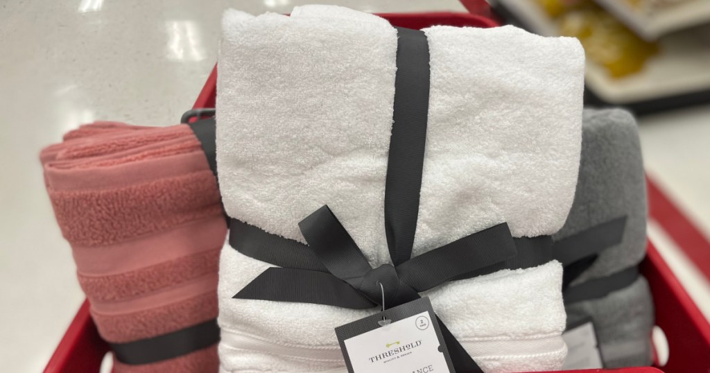 pink, gray and white blanket in cart 