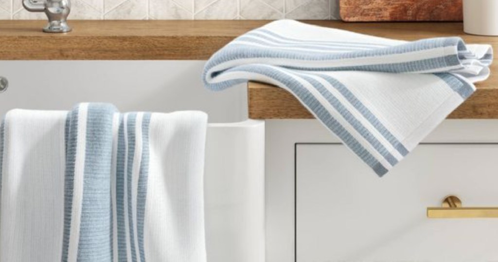 white kitchen towels with blue stripe on counter 