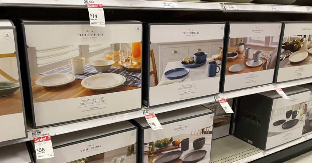 white dinnerware sets in boxes on shelf 