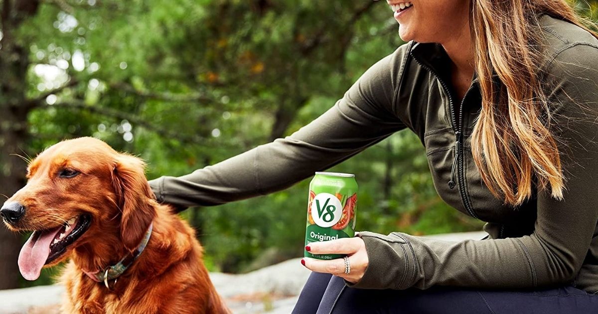 woman with her dog drinking V8 juice
