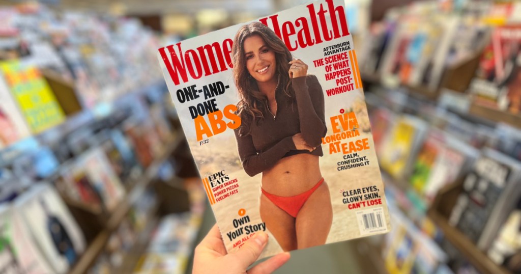 person holding copy of Womens Health Magazine in store aisle