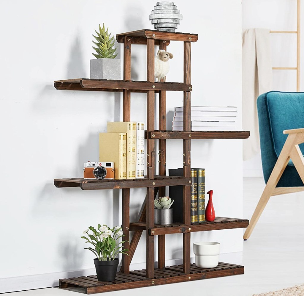 decor and books displayed on a brown wood plant stand