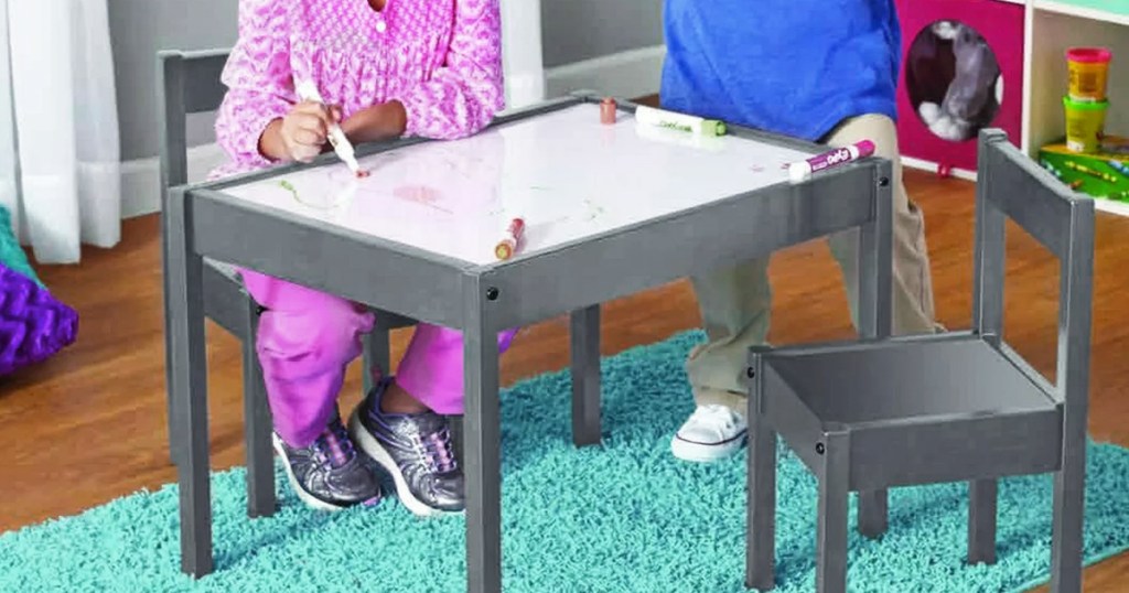 kids coloring on a dry erase table