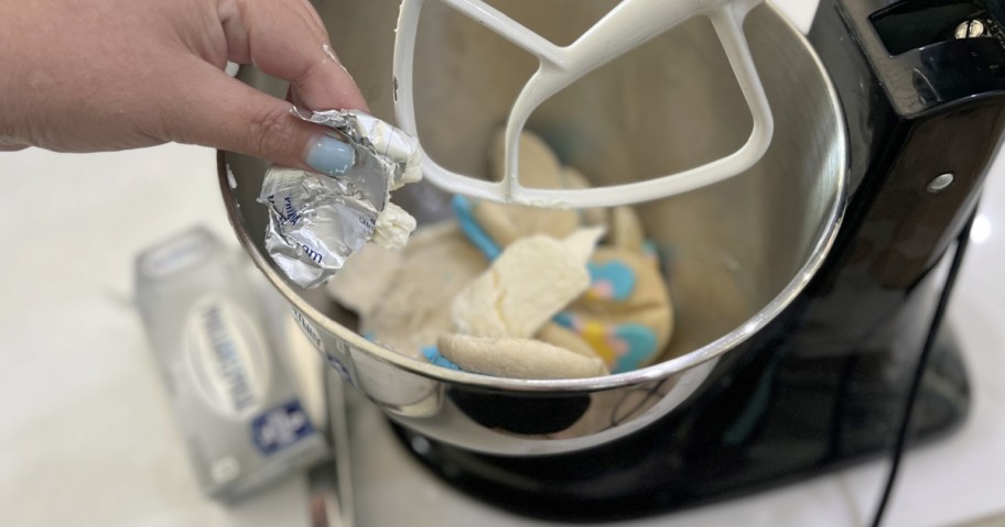 adding cream cheese to cookie crumbs